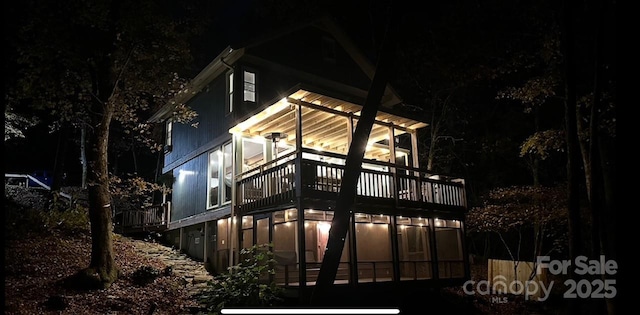 630 Shumont Rd, Black Mountain, NC 28711 - back of house at night with a balcony and a sunroom
