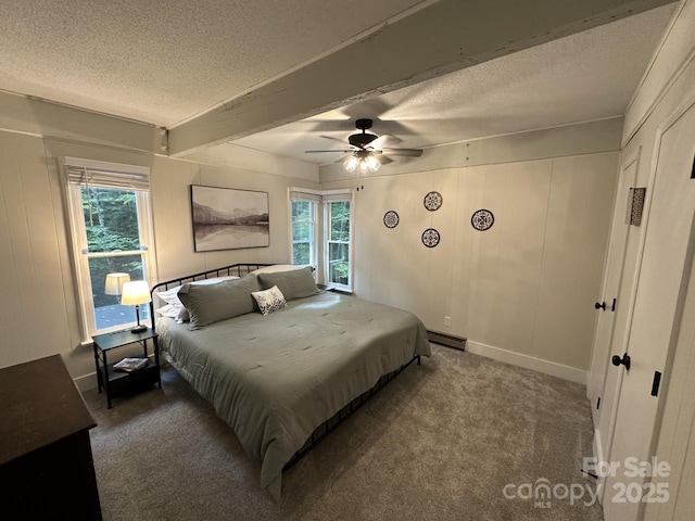 630 Shumont Rd, Black Mountain, NC 28711 - carpeted bedroom with a textured ceiling, multiple windows, a baseboard radiator, beam ceiling, and ceiling fan
