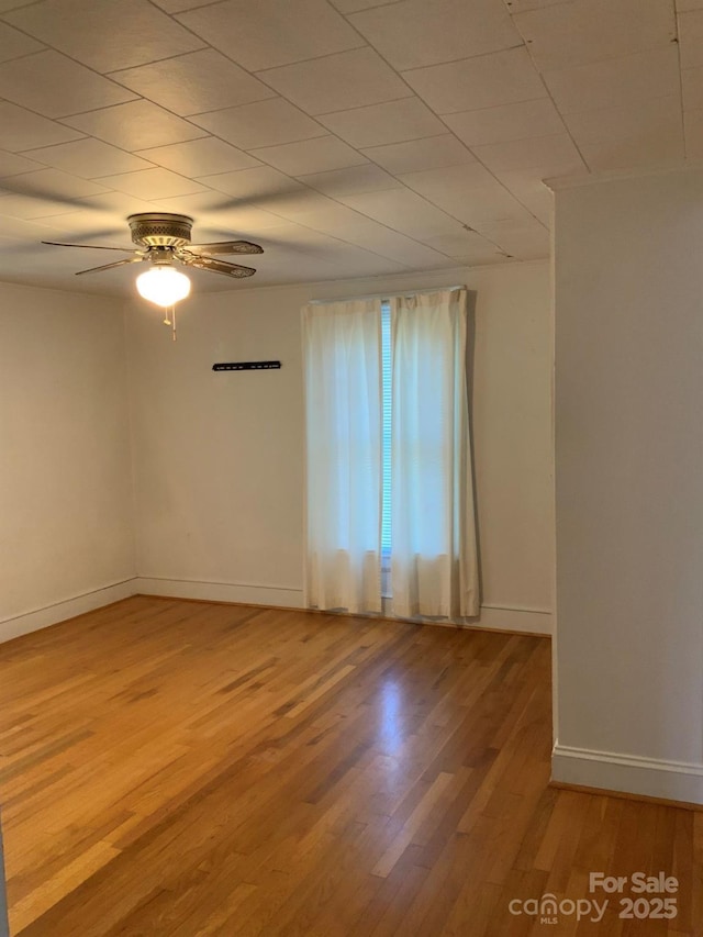 1721 9th Ave NE, Hickory, NC 28601 - empty room with wood finished floors, ceiling fan, and baseboards