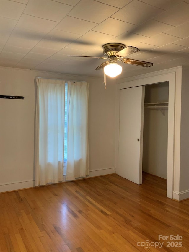 1721 9th Ave NE, Hickory, NC 28601 - unfurnished bedroom with light wood-style floors, a ceiling fan, a closet, and baseboards