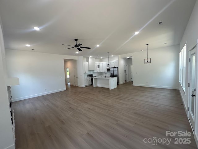 953 Mike Cir, Spartanburg, SC 29303 - unfurnished living room with a sink, a ceiling fan, baseboards, wood finished floors, and recessed lighting