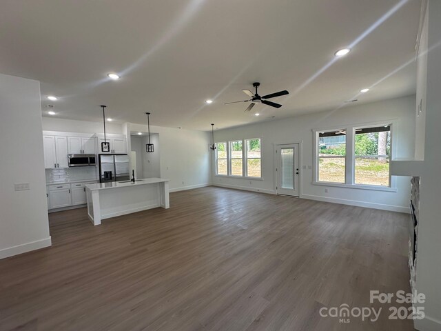 953 Mike Cir, Spartanburg, SC 29303 - unfurnished living room featuring a ceiling fan, baseboards, dark wood finished floors, recessed lighting, and a sink