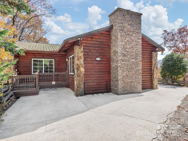 110 Garden Knoll Rd, Franklin, NC 28734 - view of property exterior featuring a chimney, a metal roof, and a patio area