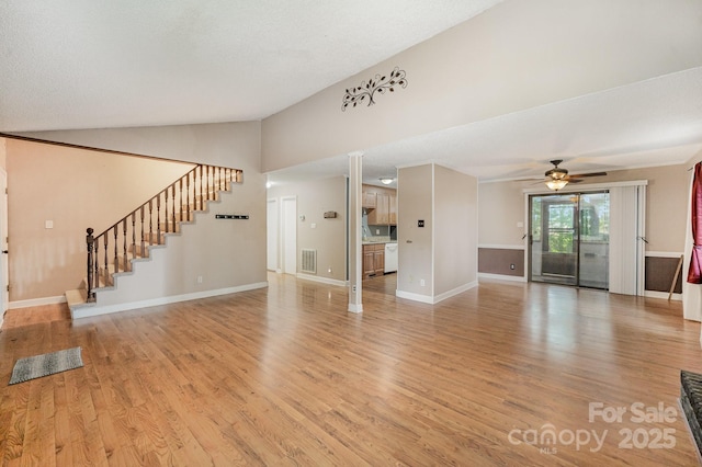 110 Hidden Valley St, Cherryville, NC 28021 - unfurnished living room featuring vaulted ceiling, a ceiling fan, light wood-type flooring, and stairway