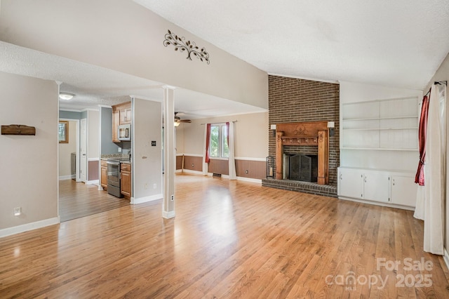 110 Hidden Valley St, Cherryville, NC 28021 - unfurnished living room with lofted ceiling, light wood-style flooring, ceiling fan, a brick fireplace, and built in features