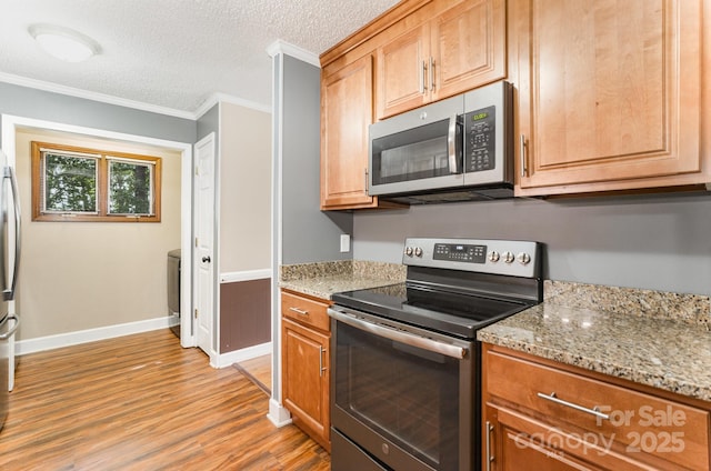 110 Hidden Valley St, Cherryville, NC 28021 - kitchen with stainless steel appliances, light wood-style floors, crown molding, a textured ceiling, and light stone countertops