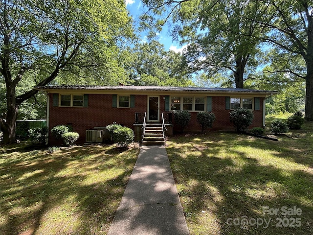 211 S Slack St, Albemarle, NC 28001 - ranch-style home with brick siding, a front yard, and central air condition unit
