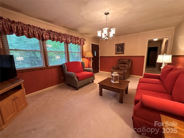 211 S Slack St, Albemarle, NC 28001 - living area with wallpapered walls, wainscoting, a chandelier, and light carpet