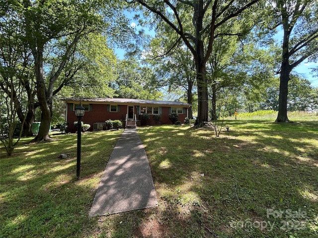 211 S Slack St, Albemarle, NC 28001 - ranch-style house featuring a front yard and brick siding