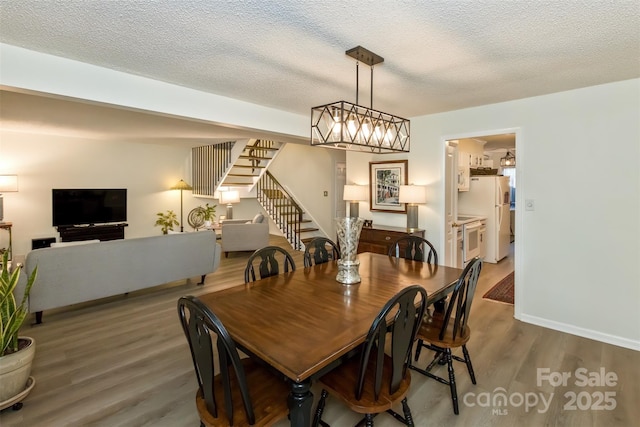503 Crowfields Ln, Asheville, NC 28803 - dining room with stairway, wood finished floors, and a textured ceiling