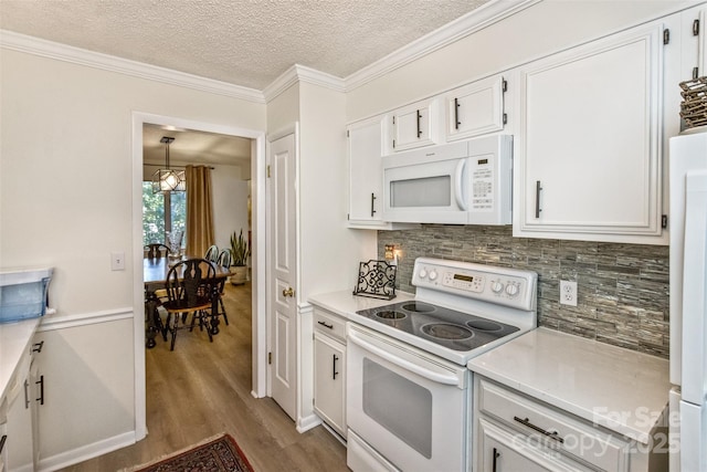 503 Crowfields Ln, Asheville, NC 28803 - kitchen featuring white appliances, wood finished floors, backsplash, light countertops, and a textured ceiling