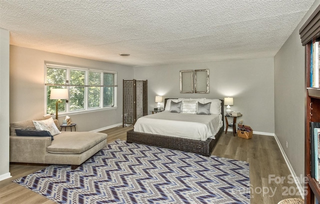 503 Crowfields Ln, Asheville, NC 28803 - bedroom featuring wood finished floors and a textured ceiling
