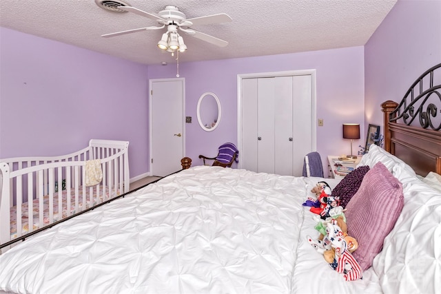 503 Crowfields Ln, Asheville, NC 28803 - bedroom featuring a closet, a textured ceiling, and a ceiling fan