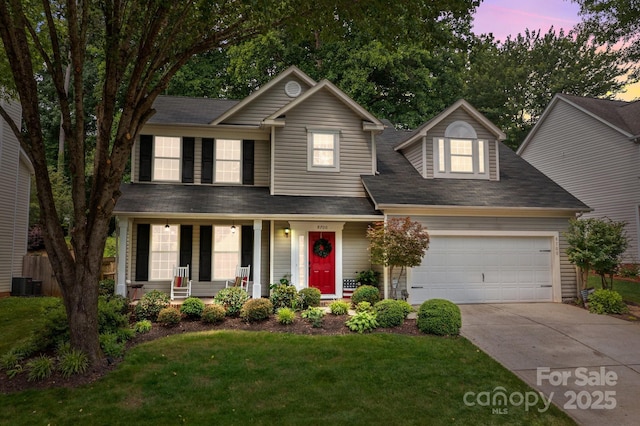 8700 Fox Tail Ln, Huntersville, NC 28078 - traditional-style home featuring a porch, a garage, driveway, a yard, and a shingled roof