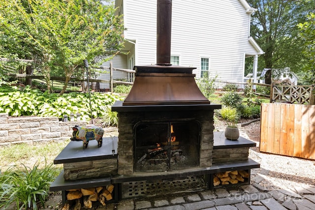8700 Fox Tail Ln, Huntersville, NC 28078 - view of patio featuring a lit fireplace