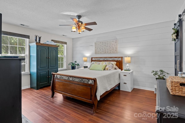 8700 Fox Tail Ln, Huntersville, NC 28078 - bedroom with dark wood-style floors, a textured ceiling, and ceiling fan