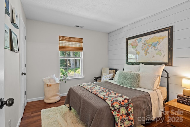 8700 Fox Tail Ln, Huntersville, NC 28078 - bedroom featuring wood finished floors, wood walls, and a textured ceiling