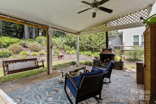 8700 Fox Tail Ln, Huntersville, NC 28078 - view of patio / terrace featuring a lit fireplace and a ceiling fan