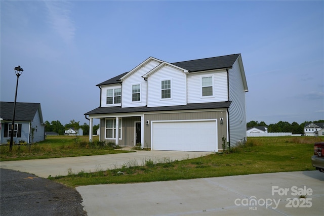 69 Ravibha Ct, Clayton, NC 27520 - traditional-style house featuring concrete driveway, an attached garage, a front lawn, and board and batten siding