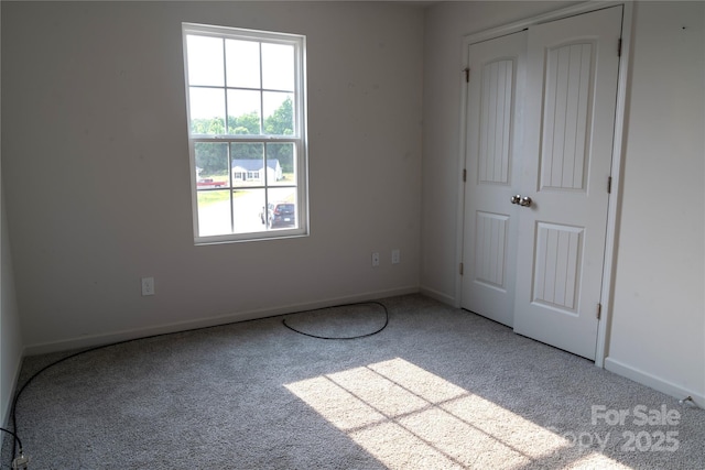 69 Ravibha Ct, Clayton, NC 27520 - unfurnished bedroom with carpet flooring, baseboards, and a closet