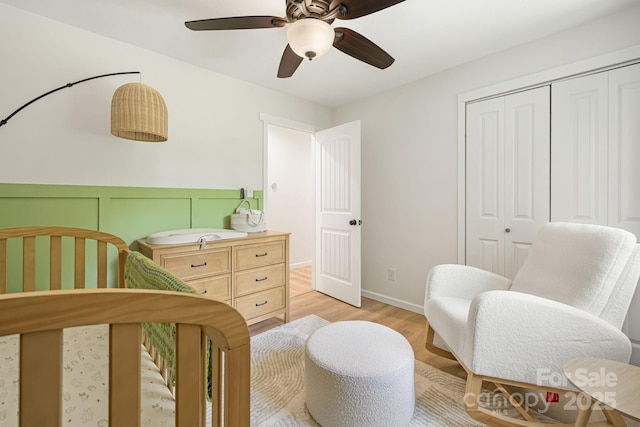 487 Duncan Creek Rd, Fletcher, NC 28732 - bedroom featuring a closet, light wood-type flooring, ceiling fan, and a wainscoted wall