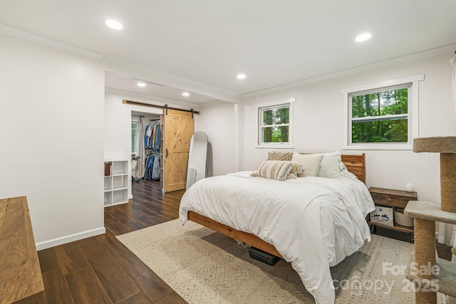487 Duncan Creek Rd, Fletcher, NC 28732 - bedroom with crown molding, a barn door, recessed lighting, wood finished floors, and a walk in closet