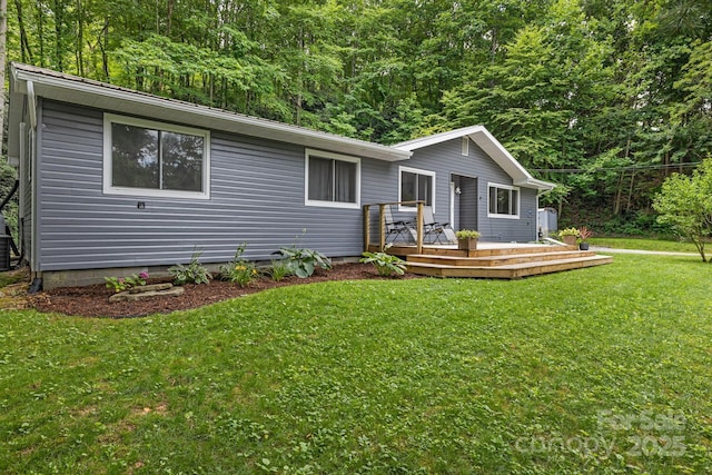 487 Duncan Creek Rd, Fletcher, NC 28732 - ranch-style home featuring a wooden deck, a front yard, and a wooded view