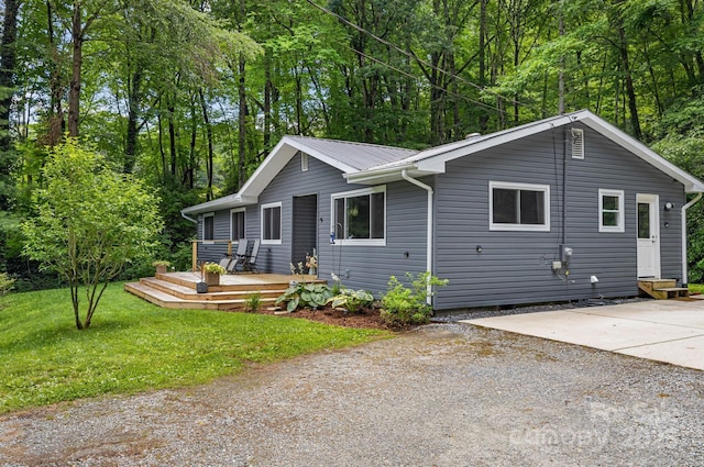 487 Duncan Creek Rd, Fletcher, NC 28732 - view of front facade with a wooden deck, a front lawn, and a metal roof