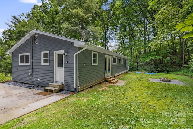 487 Duncan Creek Rd, Fletcher, NC 28732 - view of home's exterior with entry steps, a fire pit, a lawn, and a patio area