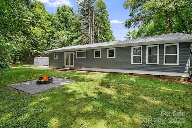 487 Duncan Creek Rd, Fletcher, NC 28732 - view of front of property with a fire pit, a front lawn, crawl space, a metal roof, and entry steps
