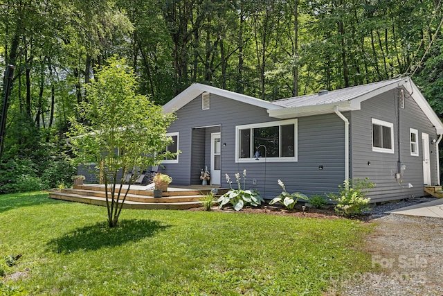 487 Duncan Creek Rd, Fletcher, NC 28732 - view of front of house featuring a metal roof, a front yard, and a wooden deck