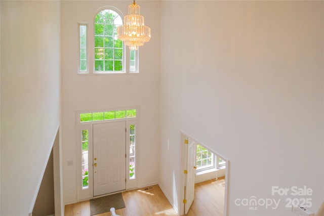 12314 Chickasaw Dr, Huntersville, NC 28078 - foyer entrance with light wood-type flooring, a chandelier, and a high ceiling