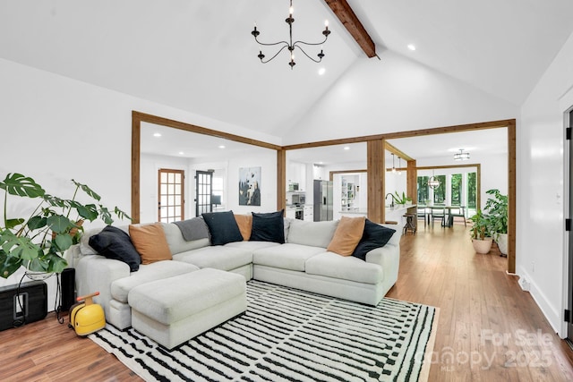316 Wade Hampton Dr, Matthews, NC 28104 - living room featuring a chandelier, beamed ceiling, recessed lighting, high vaulted ceiling, and light wood-type flooring