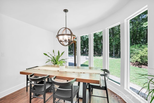 316 Wade Hampton Dr, Matthews, NC 28104 - dining room featuring healthy amount of natural light, a chandelier, baseboards, and dark wood-style flooring