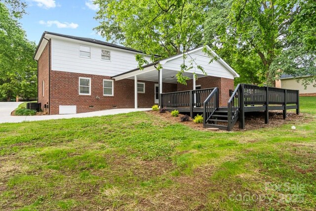 5811 Gettysburg Dr, Concord, NC 28027 - back of property featuring a yard, brick siding, a wooden deck, and crawl space