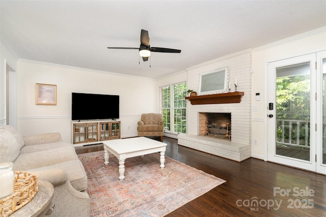 139 Palaside Dr NE, Concord, NC 28025 - living area with wood finished floors, a ceiling fan, ornamental molding, a brick fireplace, and a baseboard heating unit