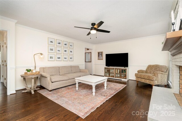 139 Palaside Dr NE, Concord, NC 28025 - living area featuring a fireplace, ceiling fan, dark wood-style floors, and crown molding