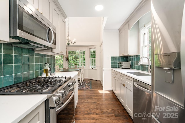 139 Palaside Dr NE, Concord, NC 28025 - kitchen featuring appliances with stainless steel finishes, light countertops, dark wood-style floors, decorative backsplash, and recessed lighting