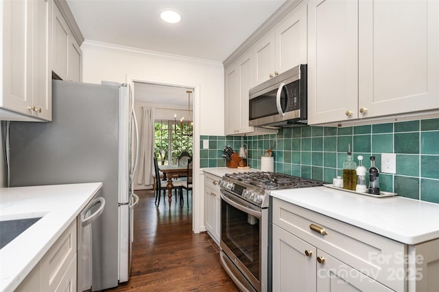 139 Palaside Dr NE, Concord, NC 28025 - kitchen featuring appliances with stainless steel finishes, crown molding, backsplash, dark wood-type flooring, and recessed lighting