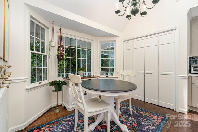 139 Palaside Dr NE, Concord, NC 28025 - dining space with dark wood-style floors, a chandelier, and lofted ceiling