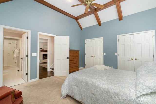 139 Palaside Dr NE, Concord, NC 28025 - bedroom with two closets, carpet, high vaulted ceiling, a fireplace, and beamed ceiling
