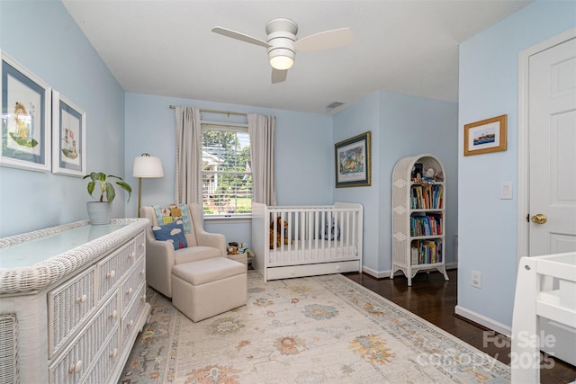 139 Palaside Dr NE, Concord, NC 28025 - bedroom with a nursery area, wood finished floors, and ceiling fan