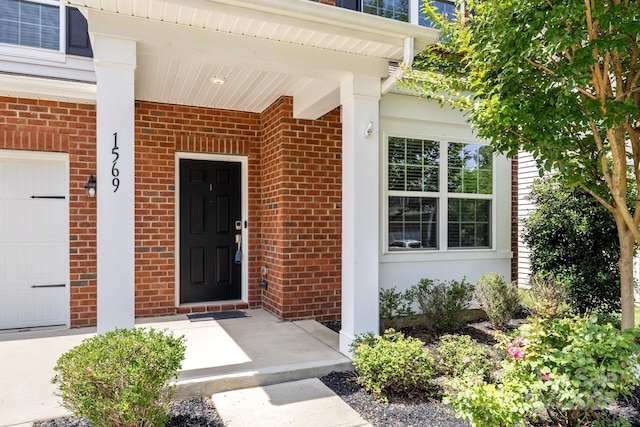 1569 Shannon Falls Dr, Fort Mill, SC 29715 - property entrance with brick siding, a garage, and covered porch