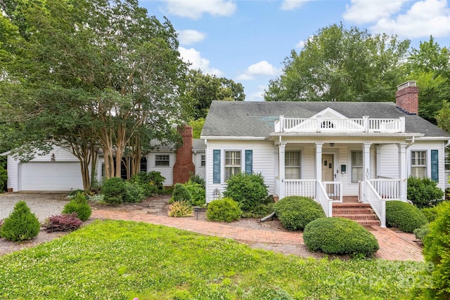 805 S Main St, Mount Holly, NC 28120 - view of front facade with a porch, a garage, a chimney, a balcony, and an outbuilding