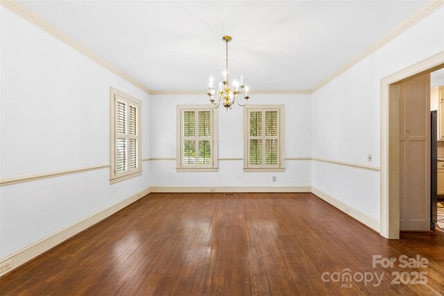 805 S Main St, Mount Holly, NC 28120 - unfurnished dining area featuring a chandelier, hardwood / wood-style flooring, and ornamental molding