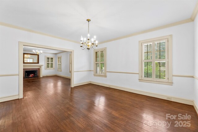 805 S Main St, Mount Holly, NC 28120 - unfurnished living room with a chandelier, hardwood / wood-style floors, ornamental molding, and a fireplace