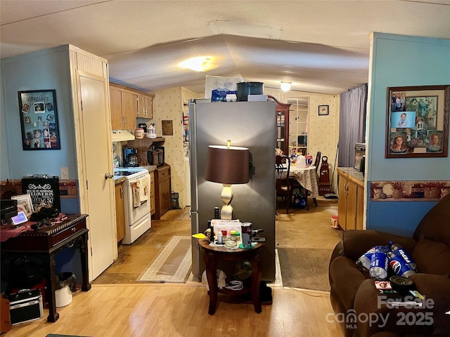 6785 Cobbs Pl, Connelly Springs, NC 28612 - kitchen featuring white range with electric cooktop, freestanding refrigerator, custom range hood, vaulted ceiling, and light wood-style flooring