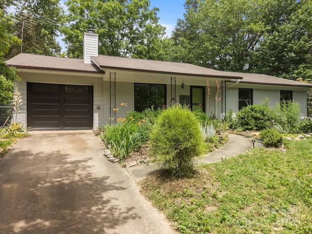 20 Summit Dr, Arden, NC 28704 - single story home with brick siding, asphalt driveway, an attached garage, and a chimney