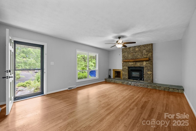 20 Summit Dr, Arden, NC 28704 - unfurnished living room with a ceiling fan, light wood finished floors, and a stone fireplace