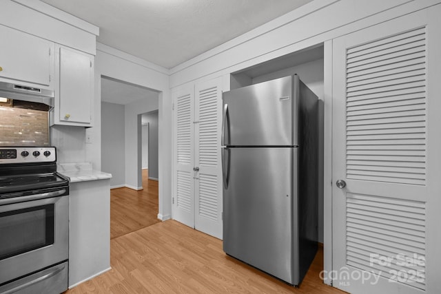 20 Summit Dr, Arden, NC 28704 - kitchen with stainless steel appliances, extractor fan, light wood-style flooring, and white cabinetry